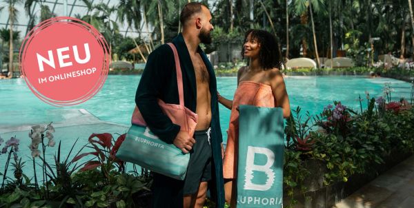 Eine Frau und ein Mann stehen mit Bluphoria Badetextilien in einer Therme