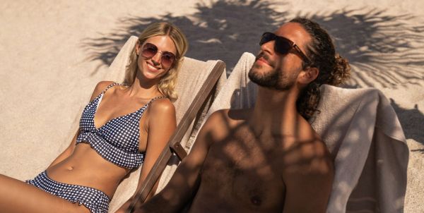 Liege unter Sonnenschirm am Sandstrand