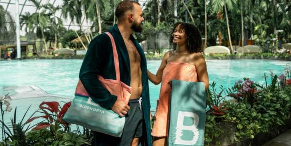 A woman and a man are standing in a spa wearing Bluphoria bathwear