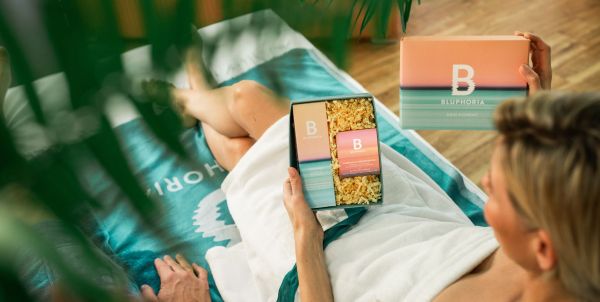Frau hält eine Geschenkbox von Bluphoria in der Hand