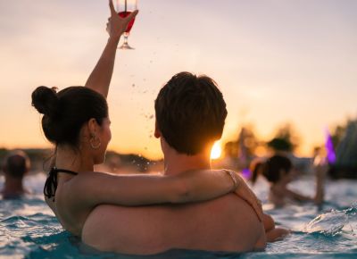 vier Personen sitzen im Pool