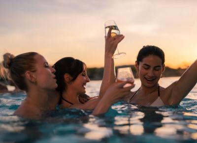 Drei Personen sitzen an einer Strand Bar